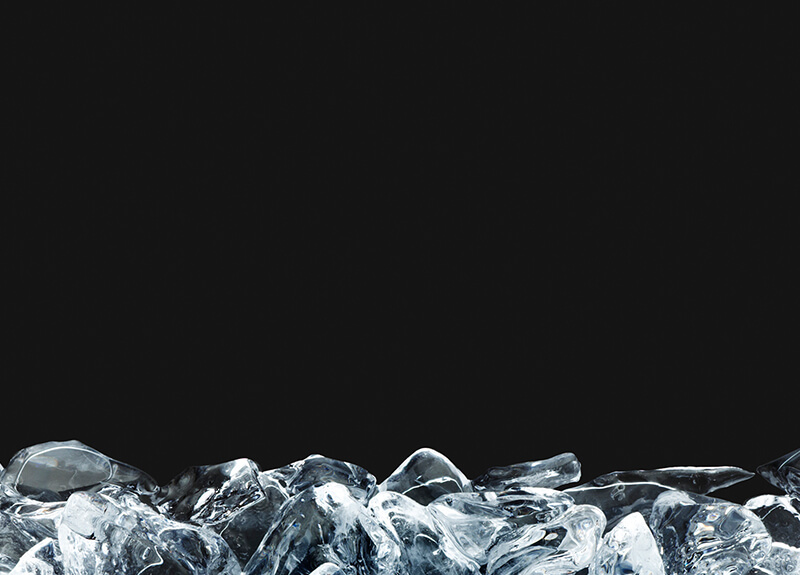 Mound of ice cubes in front of black background