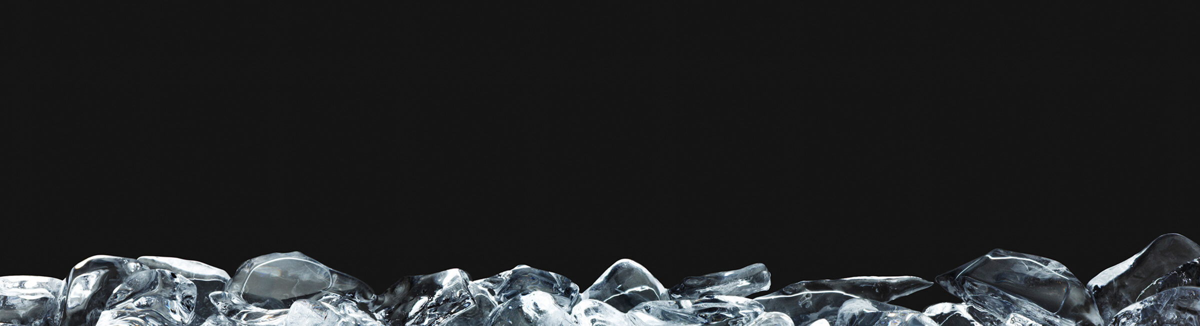 Mound of ice cubes in front of black background